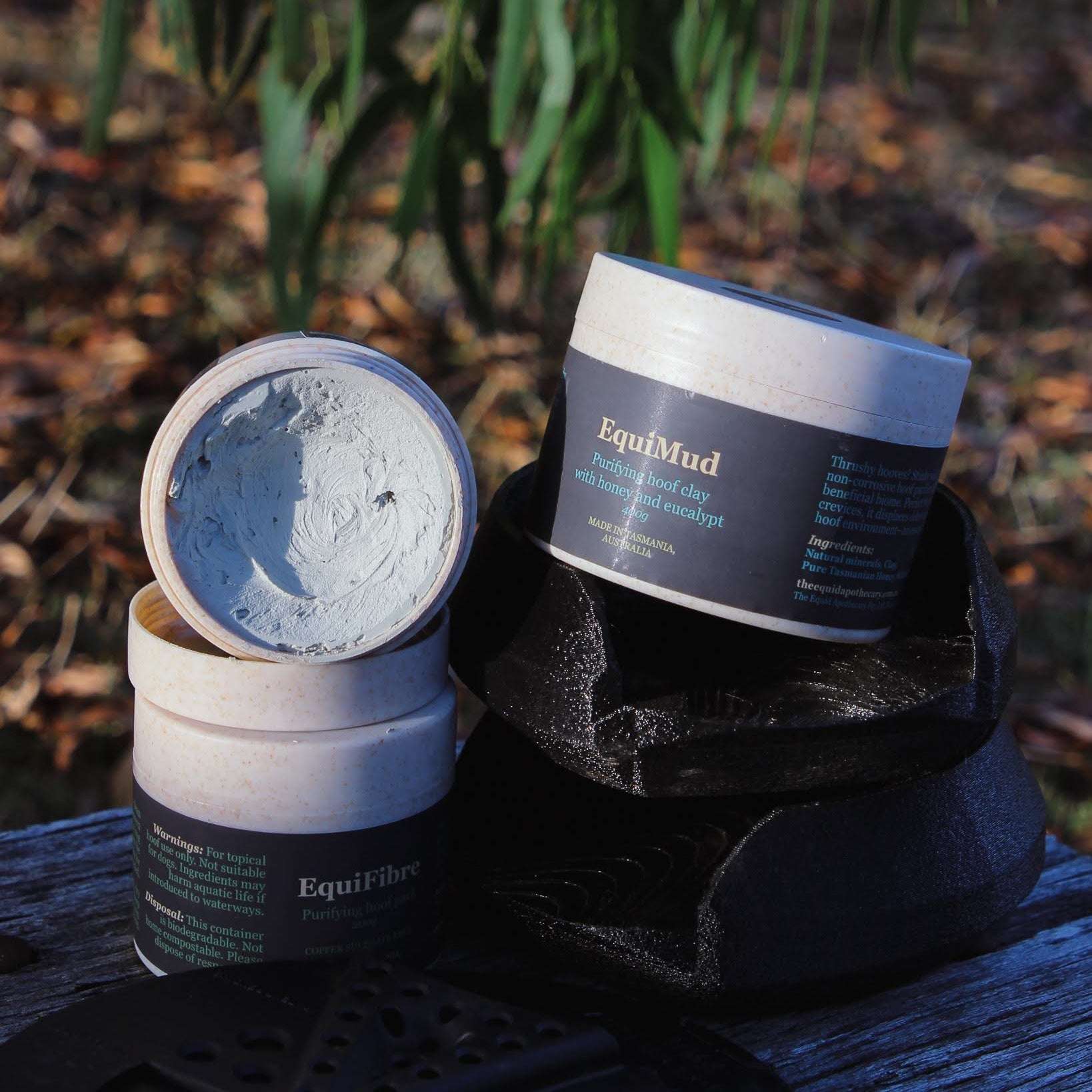 EquiMud hoof clay sitting in a MoreAid Squish Pad with a 3D hoofcare pad laying beside.